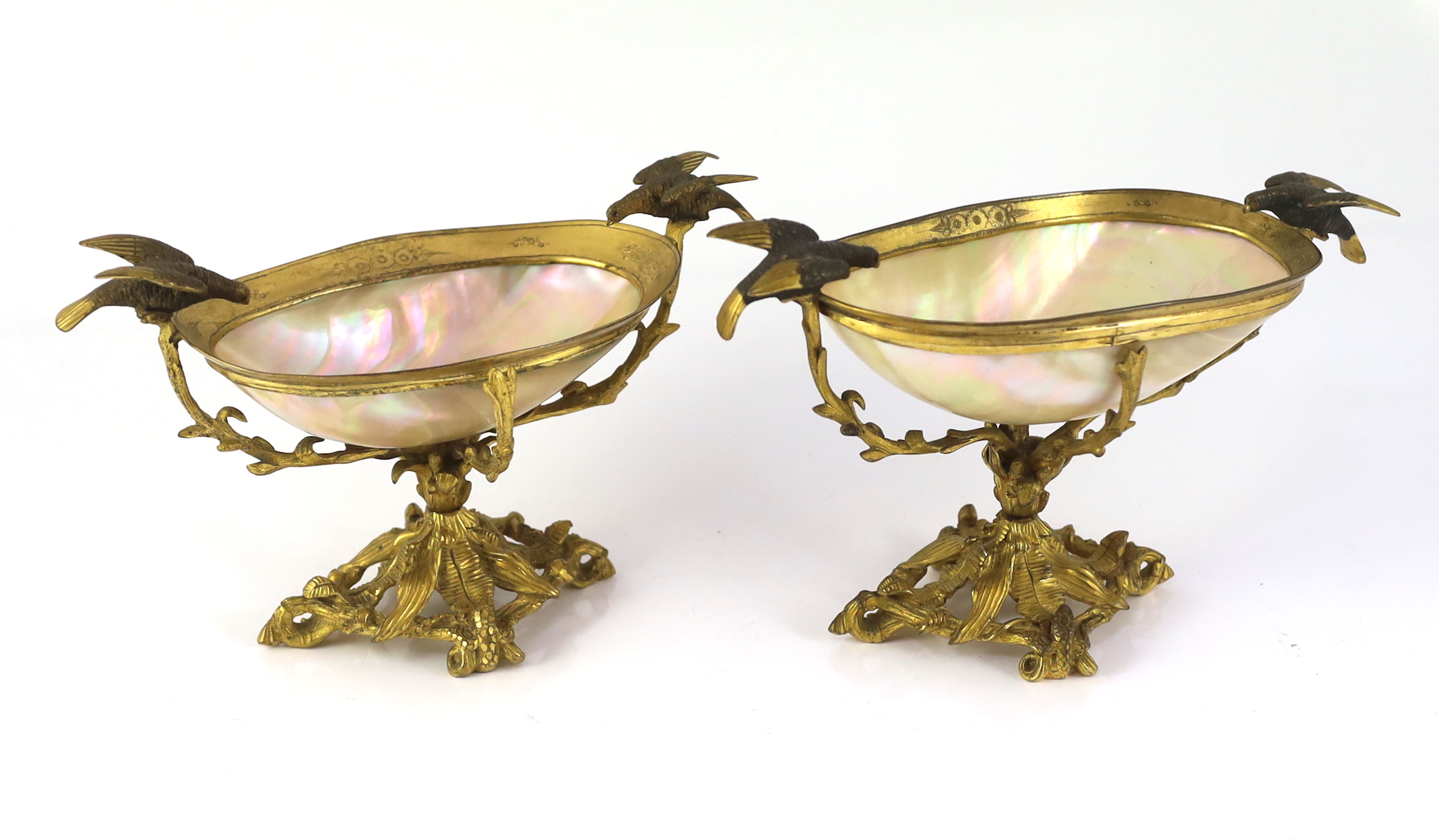 A graduated pair of 19th century Continental ormolu mounted mother of pearl pedestal bowls